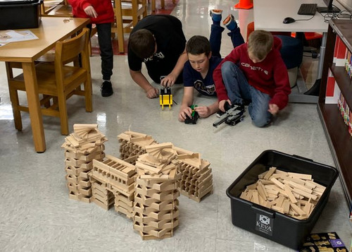 students playing with Keva planks and catapults