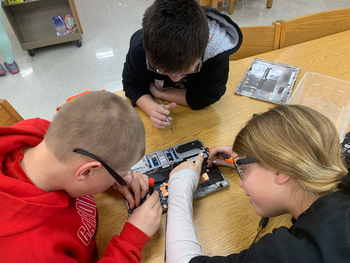students taking apart a chromebook